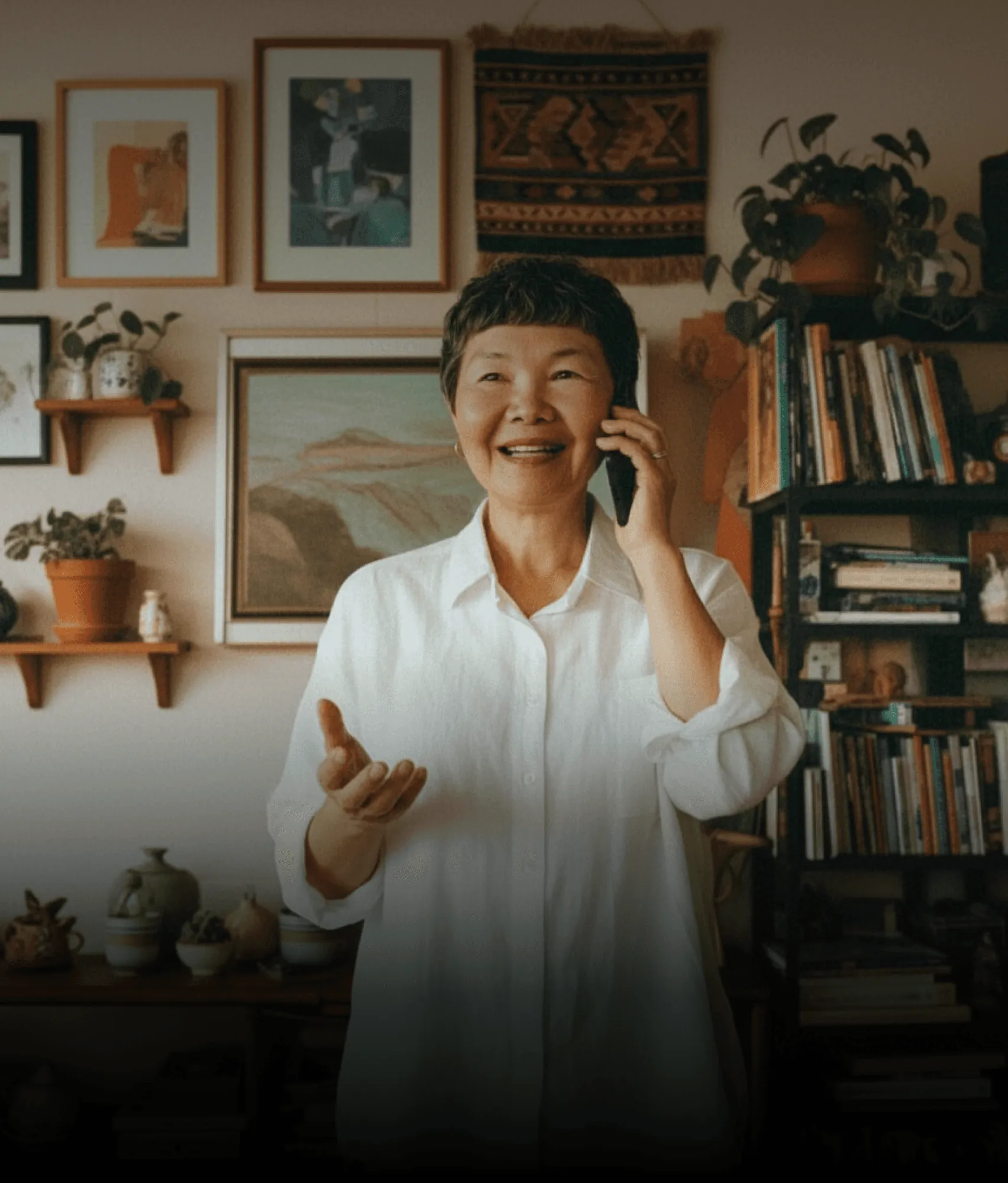 An older adult speaking on the phone at home
