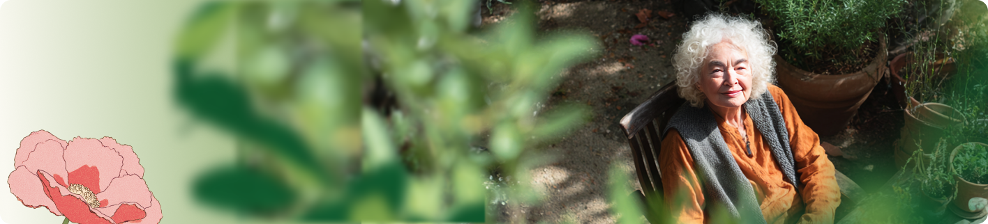 An older adult sitting comfortably in her garden