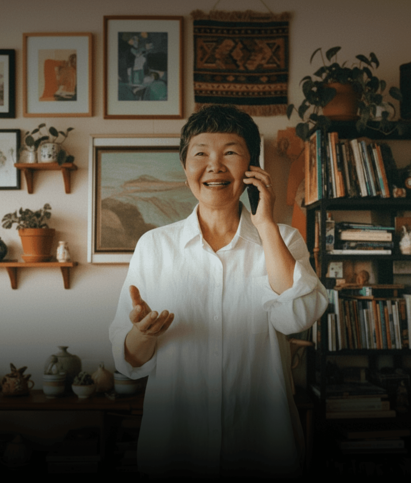 An older adult speaking on the phone at home