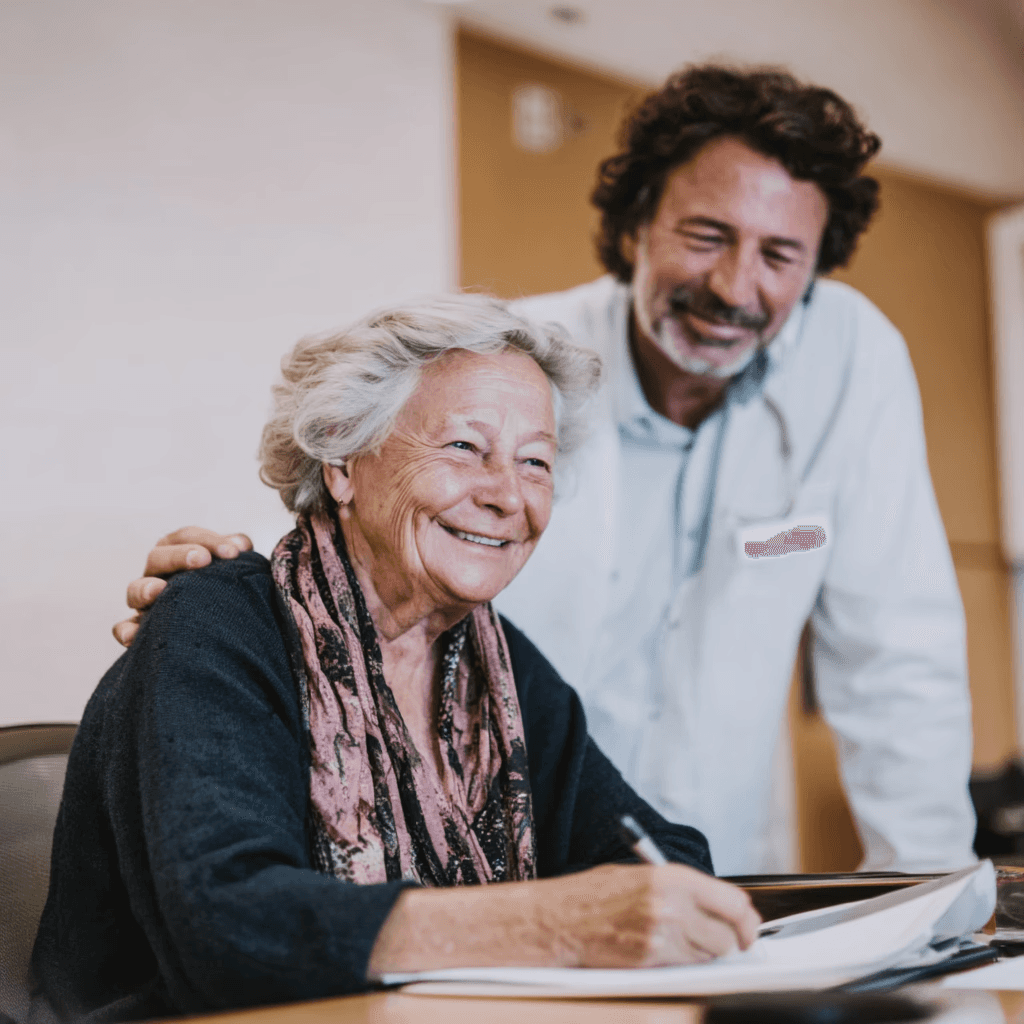 An advocate helping a smiling woman with paperwork